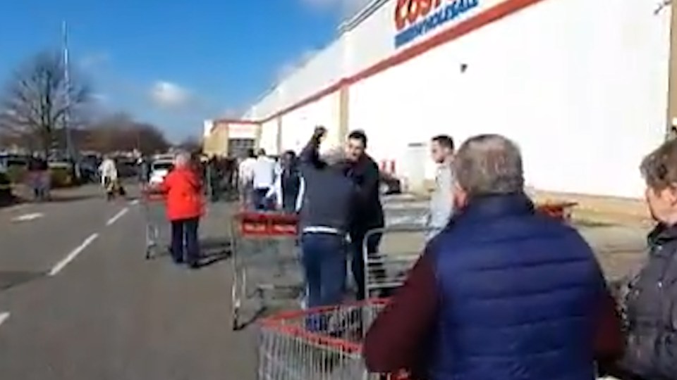 Two men could be seen yelling at each other as they queued outside the Costco