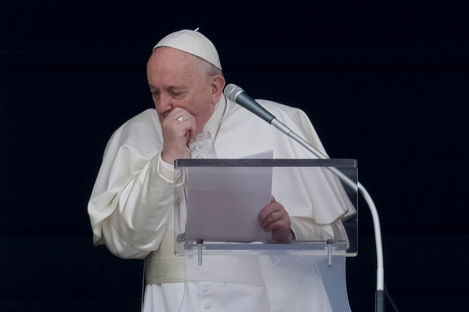 Pope Francis coughs as he tells pilgrims that he is not going to a week-long spiritual retreat in the Roman countryside because of a cold