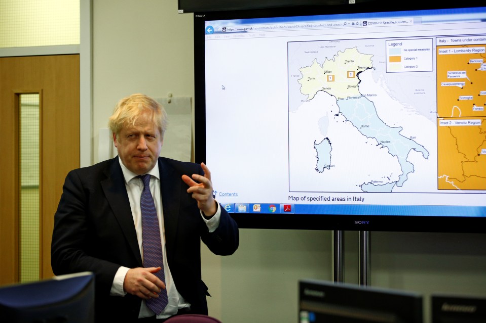 Britain’s Prime Minister Boris Johnson visits a laboratory at the Public Health England National Infection Service in Colindale