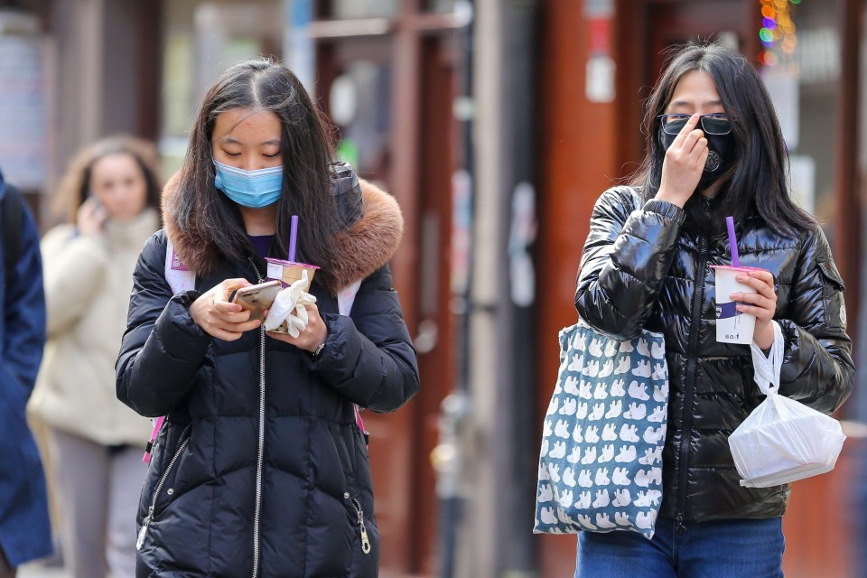 Women wearing face masks in London’s Chinatown as the coronavirus spreads