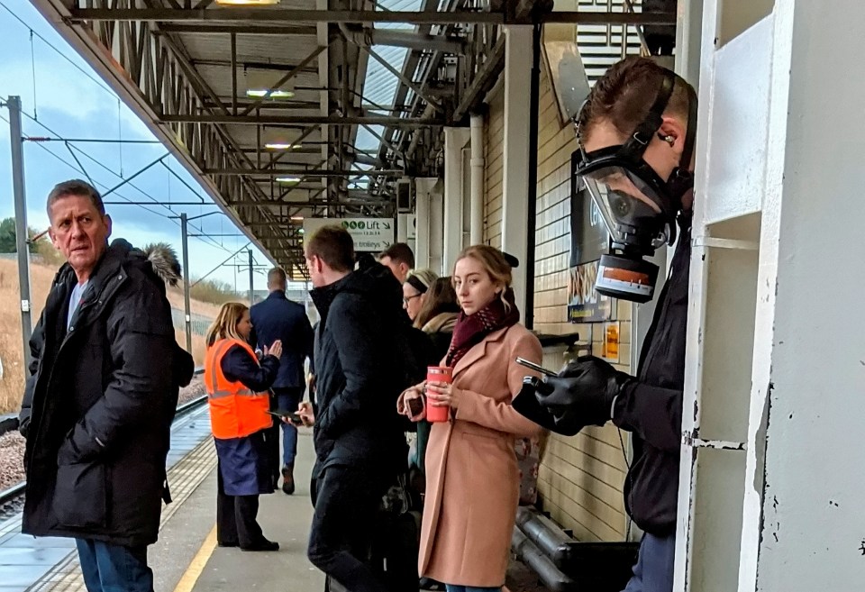 A man wears a gas mask at a busy train station as fears of coronavirus spread