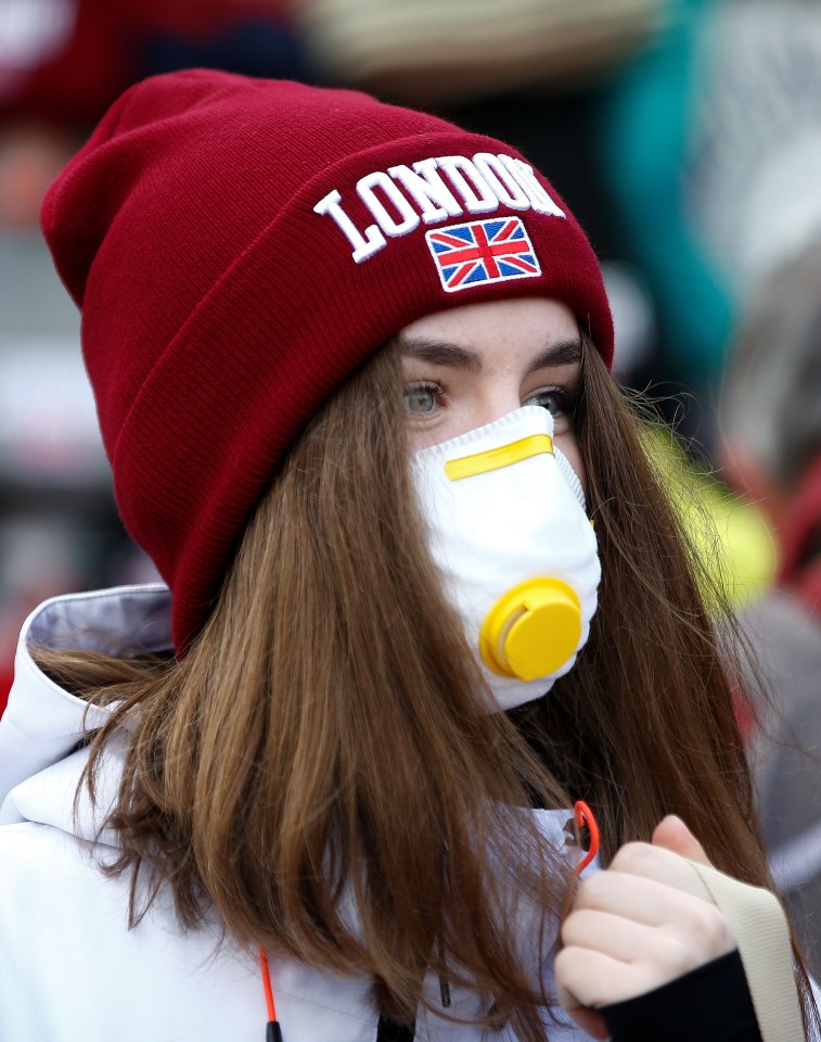 A girl is pictured wearing a protective mask in London