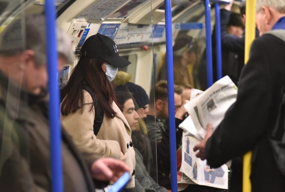  A woman wears a face mask on the tube in London today