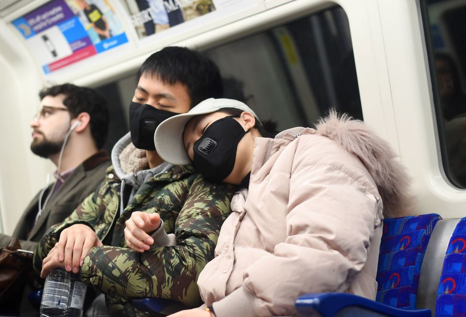  Commuters wear masks on the tube