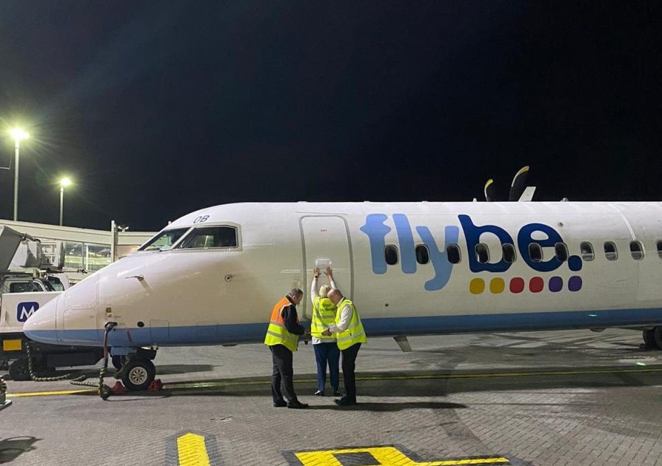  Staff at Southampton Airport place a seizure notice on a grounded FlyBe plane