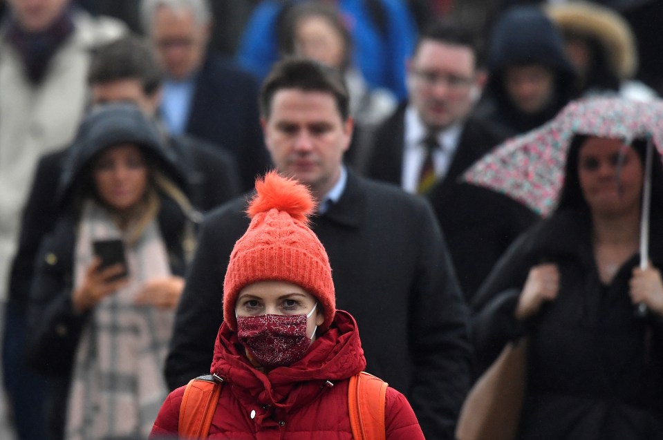  Commuters seen wearing face masks on London Bridge as the UK is hit by the spread of coronavirus