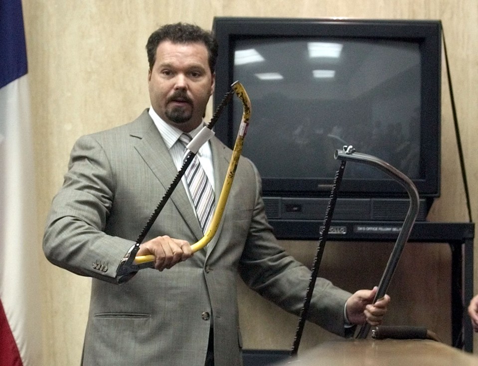  Durst's defense lawyer Chip Lewis showing two saws Durst used to cut up the body of Morris Black