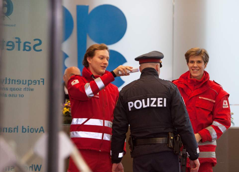 Red Cross medics check the temperature of a policeman in Vienna