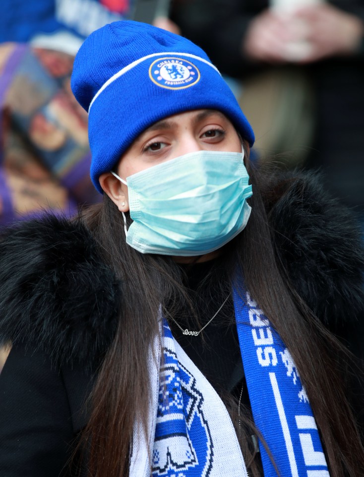 A fan in a mask during the Premier League match at Stamford Bridge