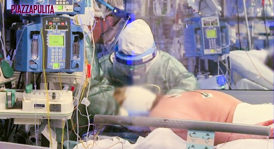  Medical staff wear protective suits to treat a coronavirus patient