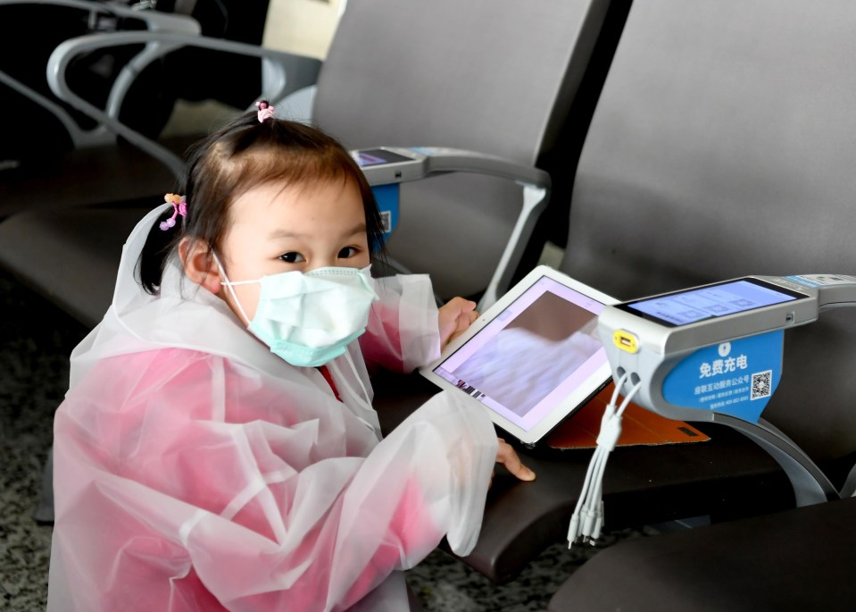 A child from Taiwan wearing a face mask at Wuhan airport in China during the coronavirus outbreak 