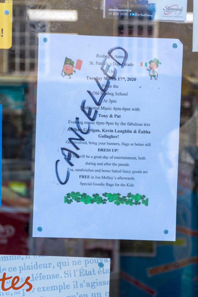  A notice in a shop window announces the cancellation of a local St. Patrick's Day Parade due to the outbreak of the killer flu