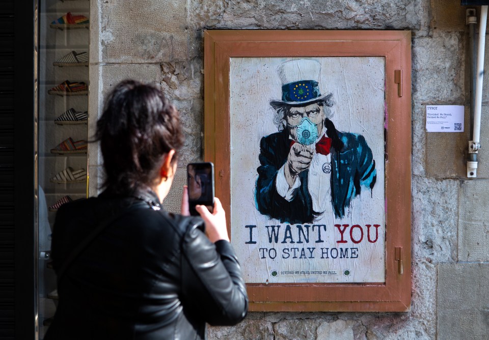  A picture of 'Uncle Sam' urges people to stay at home in a street in Barcelona