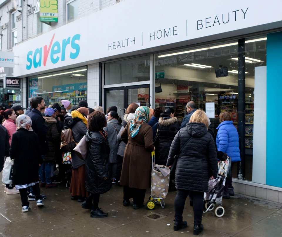  People queue to buy toilet paper outside a Savers store in Wood Green