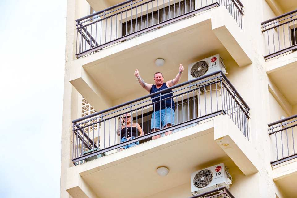  British holidaymakers were seen on their balconies in the popular seaside resort as Spain went into lockdown