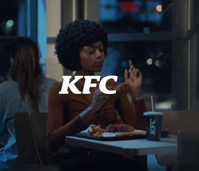 It features people eating fried chicken and licking their fingers after