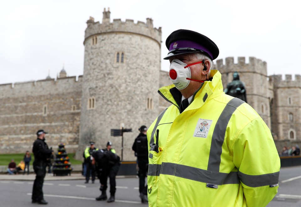  A security guard in a face mask stands outside of Windsor Castle