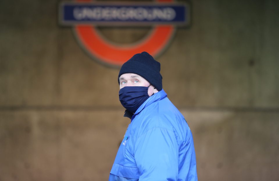  A man wears a face mask at a Tube station