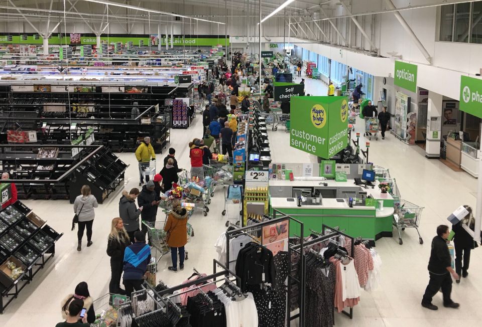  Customers queue to pay for their shopping in an ASDA supermarket in West Bridgford, Nottingham, at 7am