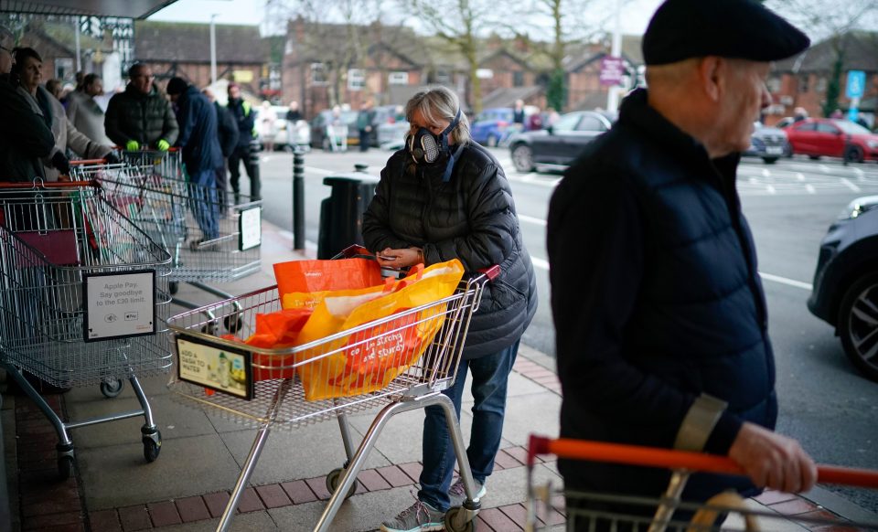  Shoppers wear face masks ready to go into stores