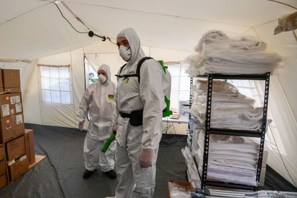  Cleaning staff from a newly operative field hospital in Cremona, near Milan. Italy is now the new epicentre of the outbreak