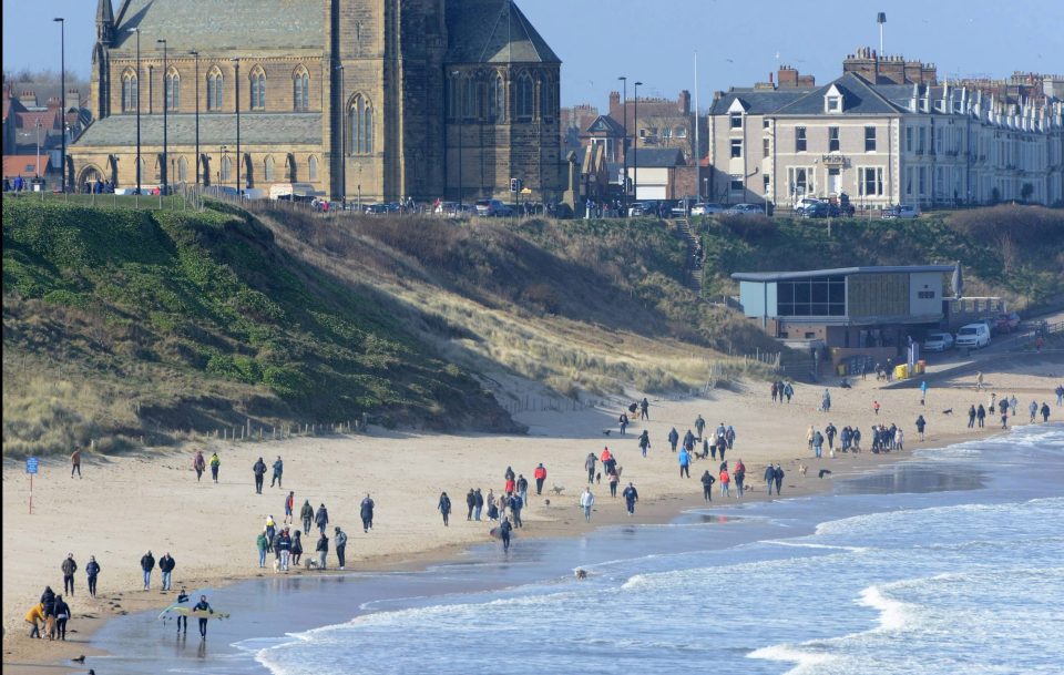  Members of the public ignore government advice to stay indoors and practice social isolation by talking a walk along the busy Tynemouth longsands beach