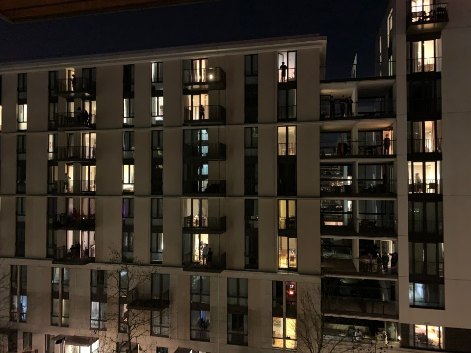  A tower block in East London is lit up with applause