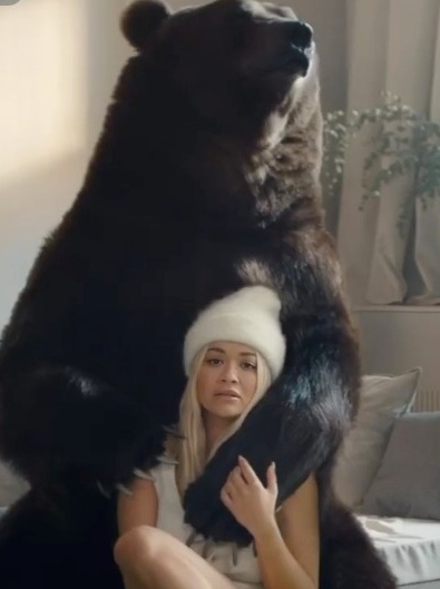  The hitmaker is also embraced by a bear to promote her new single