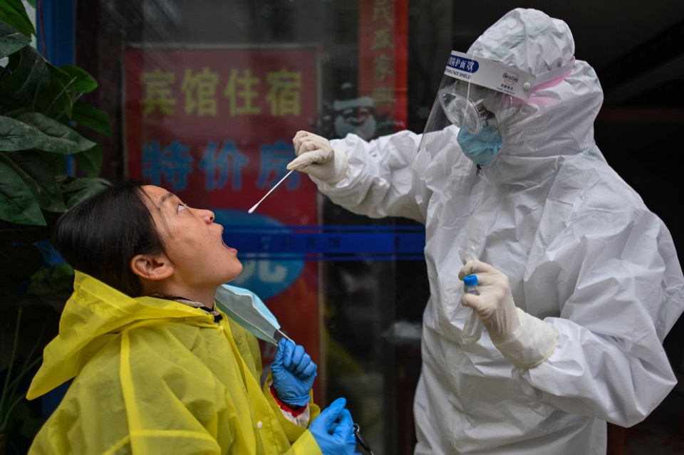 A resident is tested for the killer virus in hard-hit Wuhan