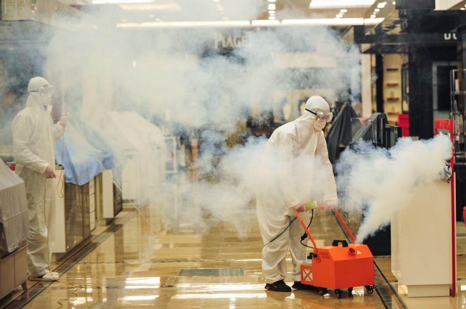 State workers fumigate the city centre as the lockdown is eased