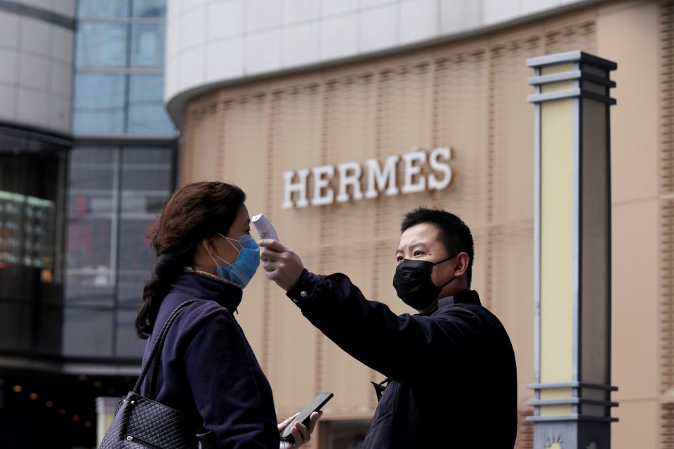 A shopper is checked over with a thermal scannner