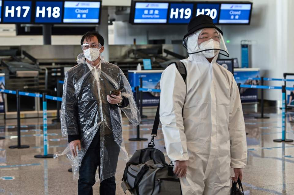  Passengers wearing protective gear at the Tianhe Airport after it was reopened