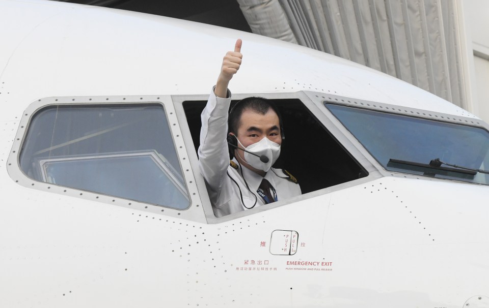 The pilot of a China Eastern airlines gives the thumbs-up before take-off at the Tianhe International Airport in Wuhan, April 8