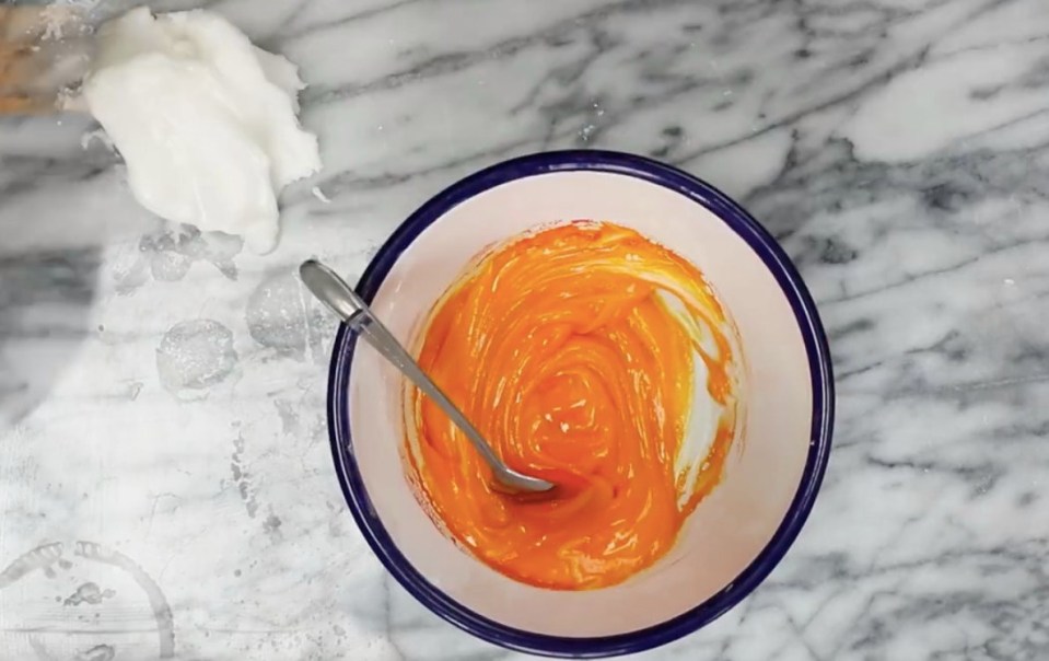 Put some fondant in a separate bowl and add colouring to make the yolk