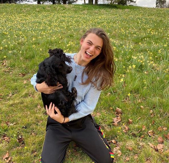 Continuing his celebrations today, Damian shared a joyous shot of him holding the family pooch in his arms