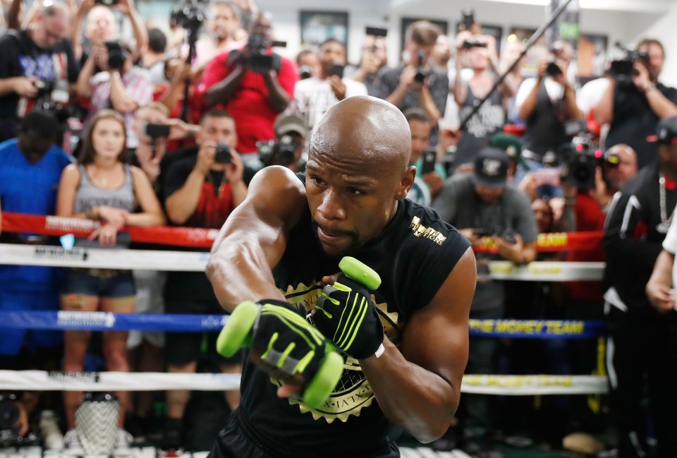 The American shadow boxes with weights in his hands