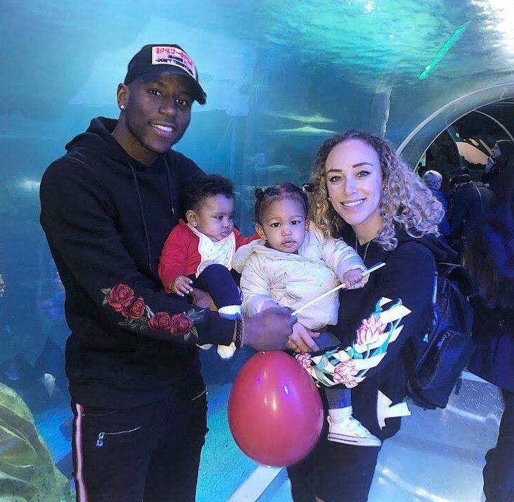  Lois holds Amora as Benik Afobe carries sister Alba in his arms on a family outing