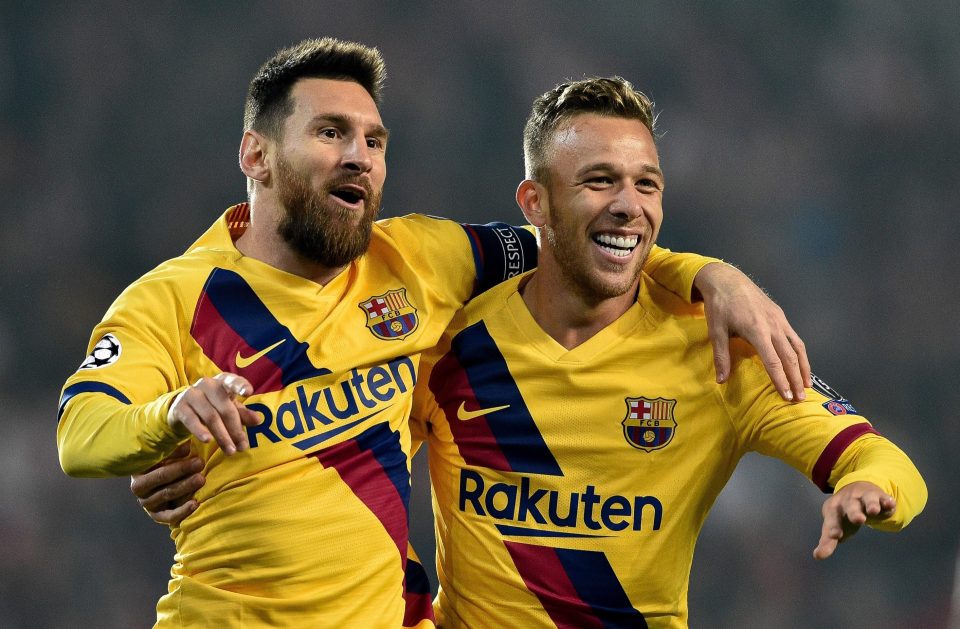  Arthur alongside Barcelona team-mate Lionel Messi