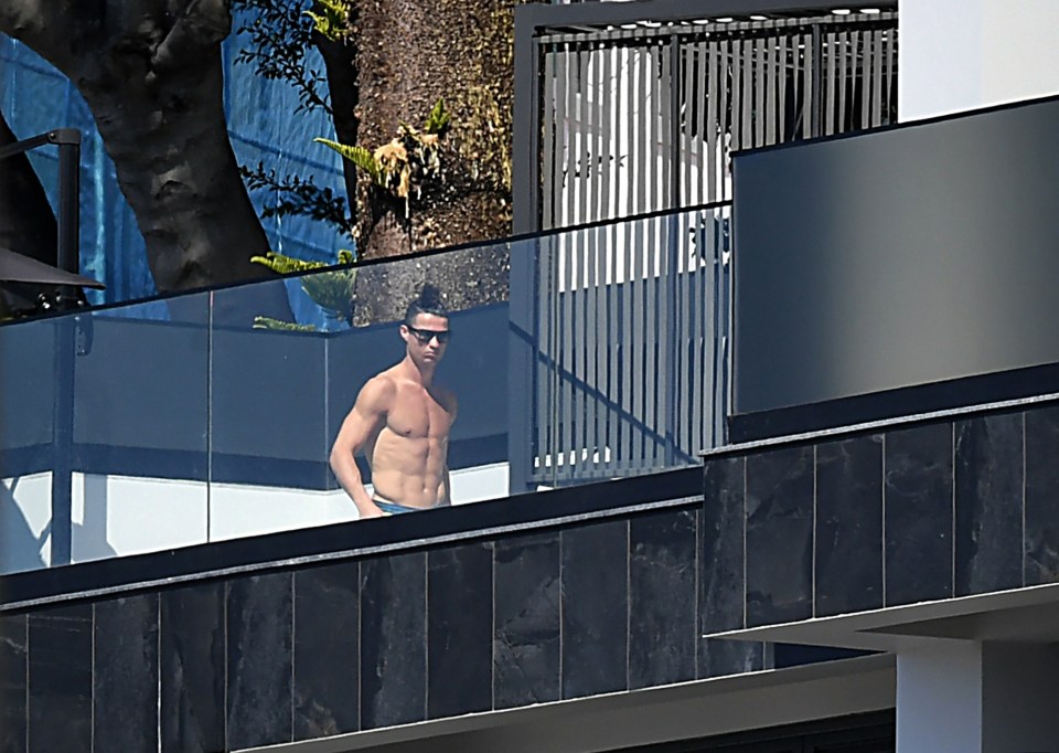  Ronaldo has been spied topping up his tan on the rooftop terrace