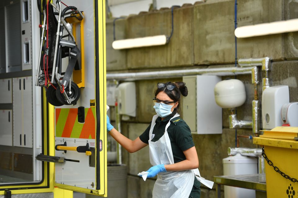  A paramedic cleans an ambulance in Swansea today