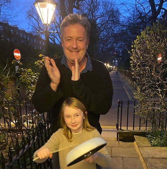  Piers and daughter Elise outside their home clapping for the NHS