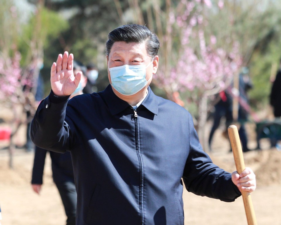 Chinese President Xi Jinping waves during a tree-planting ceremony on April 3