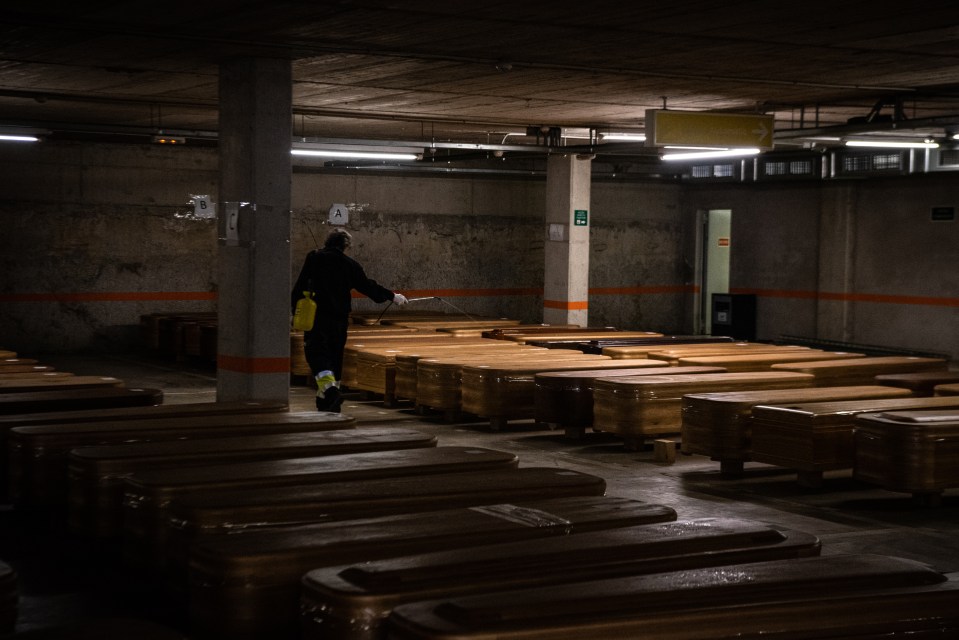  Coffins are laid out in a car park in Barcelona last week