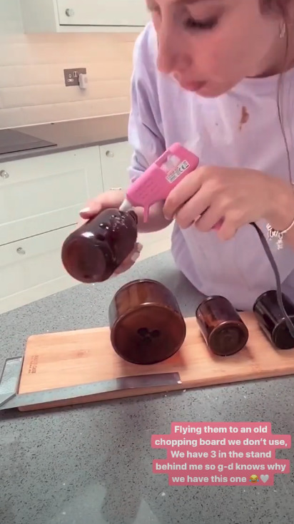 She left old candles to soak and then glued them onto the wooden chopping board