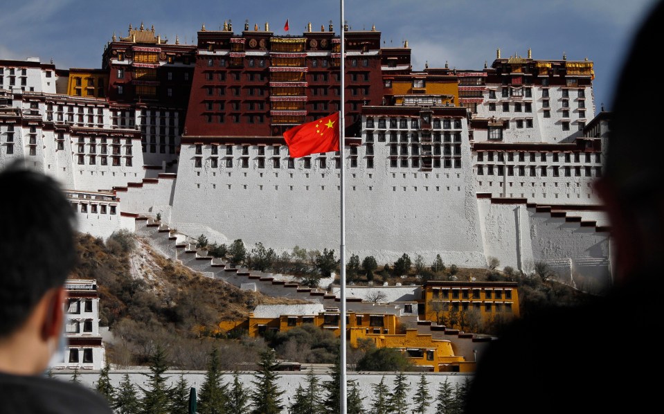 A Chinese national flag flies at half-mast at Potala Palace during the three minutes of silence on April 4