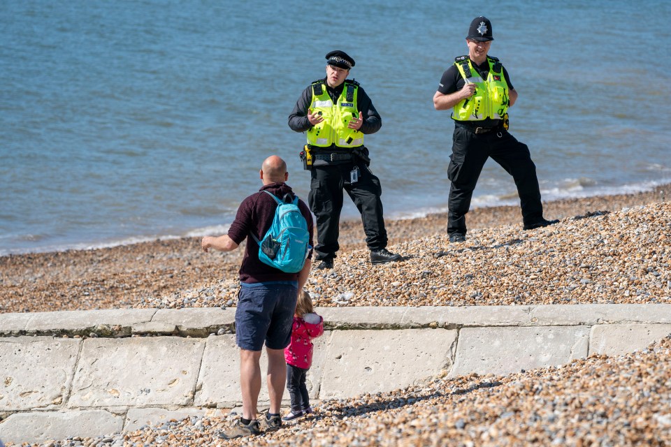 Officers speak to a man with his child in Brighton