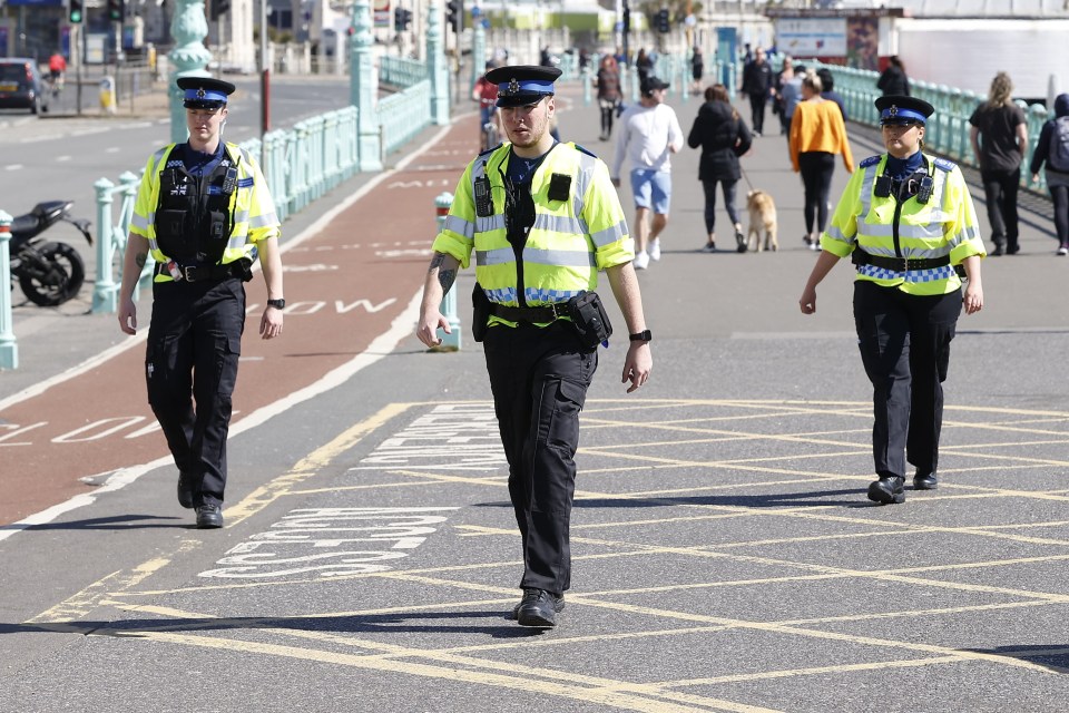 Officers walk through Brighton today as Brits were told to stay home