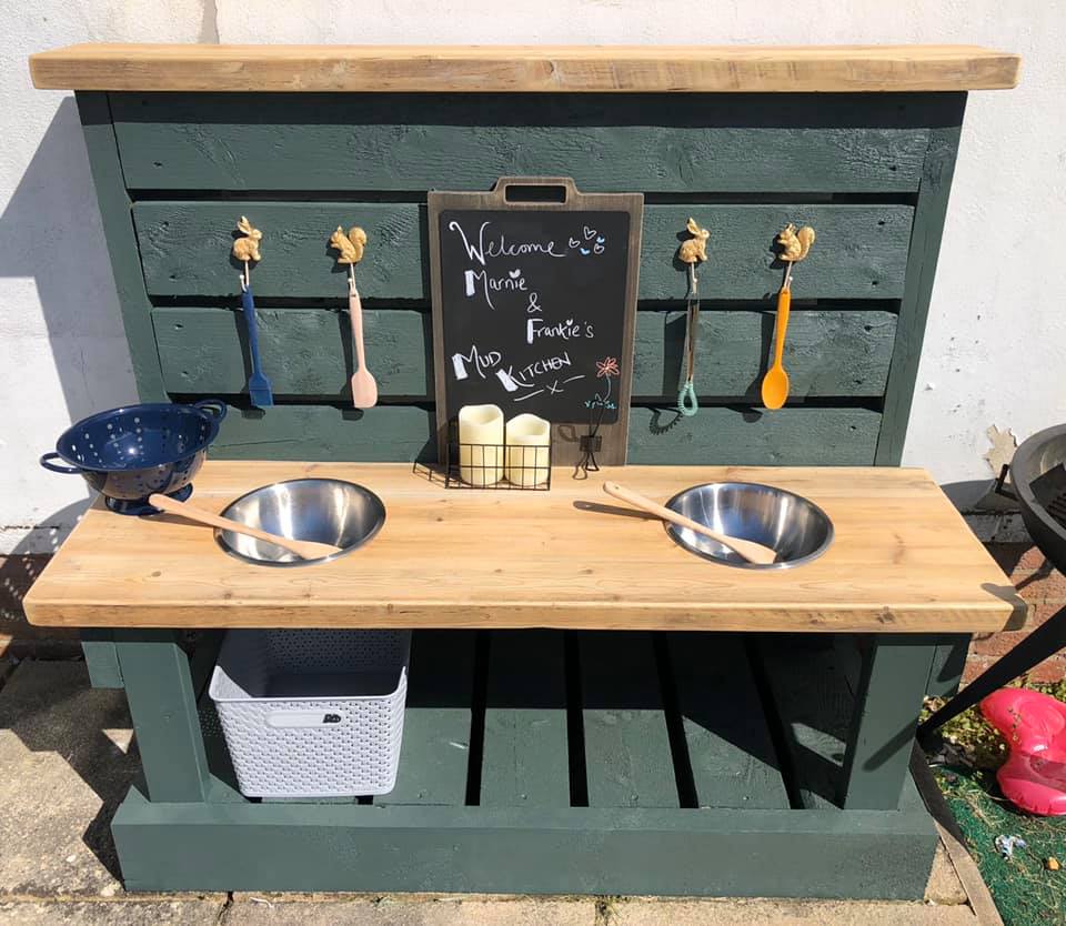 A dad has been praised for creating a "mud kitchen" out of old wood for his daughters