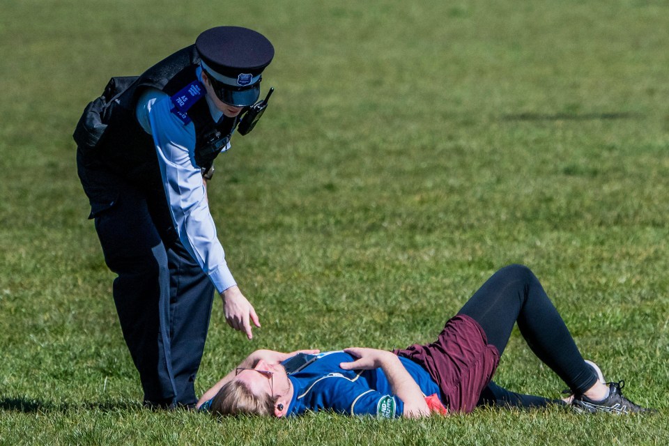 Police patrol a packed Clapham Common earlier today