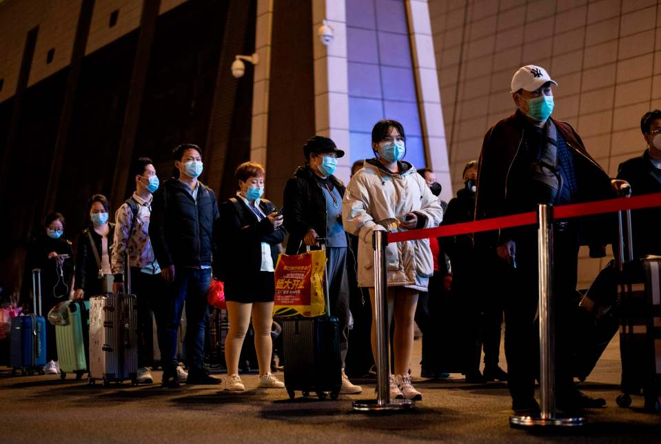  Passengers queue to board trains to elsewhere in China